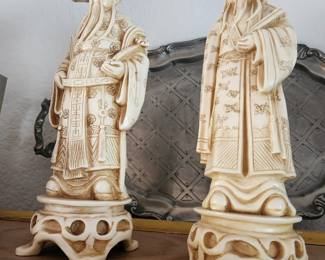 Chinese Elder or Scholar Figurine on the Left. Carved Chinese 'wise man' figurine on the Right.