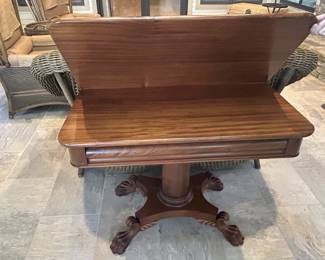 Antique mahogany flip-top game table, carved claw feet, pedestal base
