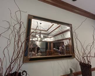 Large gilt wood-framed wall mirror, ornate beveled edge