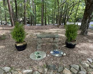 Concrete frog-leg garden bench with turtle stepping stones and glazed planters