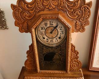 E. Ingraham gingerbread mantel clock, featuring an ornate pressed oak case with intricate carvings