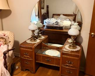 1930s-1940s Art Deco waterfall vanity with a large round mirror and drop center