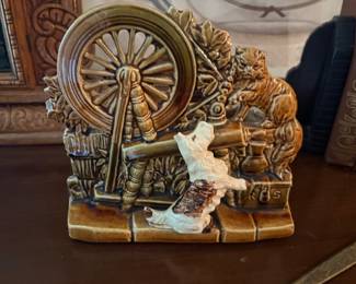 vintage McCoy Pottery planter features a charming spinning wheel scene with a textured brown ceramic finish and a playful Scottie dog and cat
