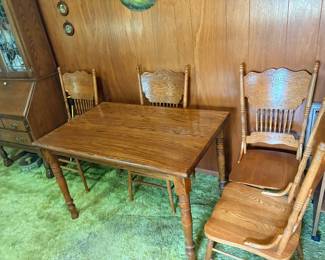 antique oak dining set, featuring a rectangular table with fluted legs and pressed-back chairs