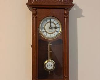 Bedford Clock Collection wall clock features a redwood finish and carved horse