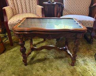J.B. Van Sciver walnut table features a glass top tray design and intricately carved legs
