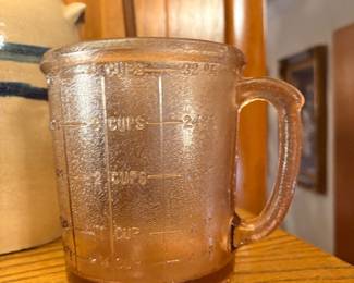 vintage Hazel-Atlas pink depression glass measuring cup, often associated with a Kellogg's promotion