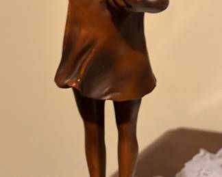 vintage bronze statue depicts a young girl blowing bubbles and is a recognized work by artist Suzanne Bizard (1873-1963) on a green marble base