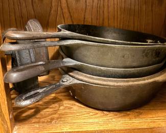 Dutch oven and several sizes of cast iron skillets