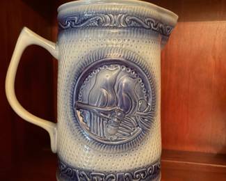 vintage Hull Pottery stoneware pitcher featuring a white textured body with a distinctive blue-glazed bluebird medallion on the side