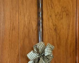 antique bed warmer features a polished brass pan with a decorative star pattern and a turned wooden handle