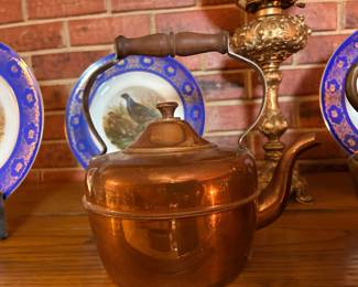 copper teapot with a wooden handle, similar to antique models from the early 1900s or those made in Portugal
