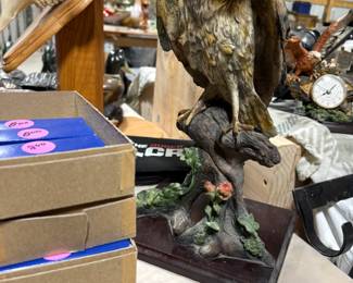 Decorative owl...to the left of which are boxes and boxes of pocket knives.