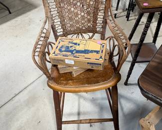 Interesting antique highchair with 3 new collectible freight truck models
