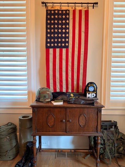 Vintage 48-star American flag with antique oak sideboard and WWII militaria