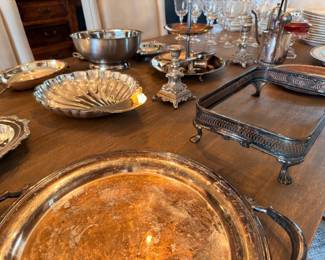 Table of silverplate trays, bowls, and serving pieces