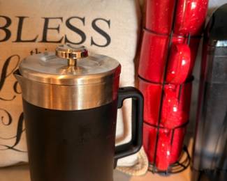 French press coffee maker and red kitchen accessories