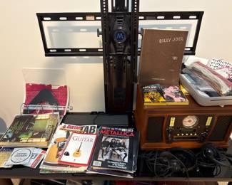 Music books, guitar magazines, and record player