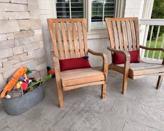 Pair of teak outdoor lounge chairs with red cushions