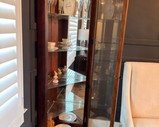 Lighted glass curio cabinet with china and stemware