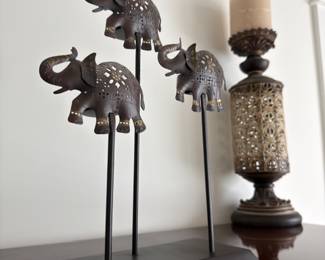 Metal elephant sculpture and pierced candle lantern