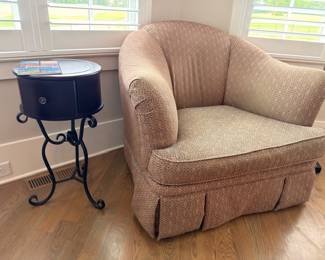Beige upholstered barrel club chair and iron accent table