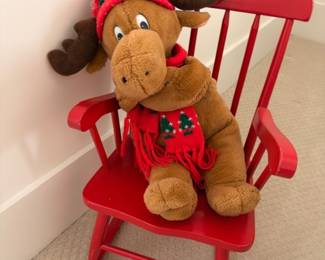 Child's red wood rocking chair with plush moose