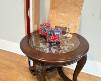 Carved wood round end table with glass top