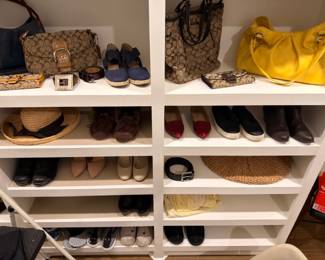 Closet of designer handbags, hats, and women's shoes