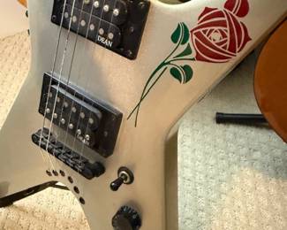 White electric Flying V guitar with rose graphic