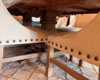 Trestle base dining table detail with nailhead chairs