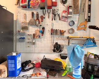 Garage workbench, pegboard hand tools, and Craftsman table saw