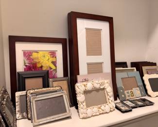 Assorted picture frames, wood, silver, and shell