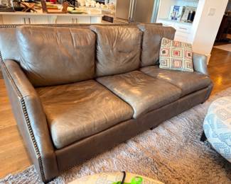 Brown leather sofa with nailhead trim