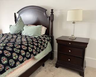 Black wood poster bed with matching nightstand