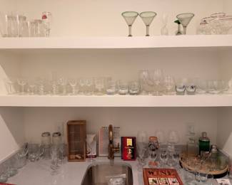 Shelves of glassware, martini glasses, and bar stemware