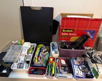 Office supplies, pens, clipboards, and mailers