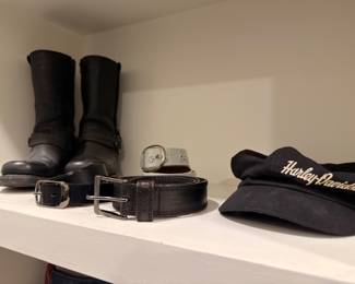 Black leather motorcycle boots, belts, and Harley-Davidson cap
