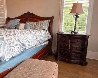 Carved cherry sleigh bed with matching nightstand
