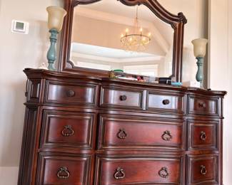 Ornate cherry triple dresser with carved mirror