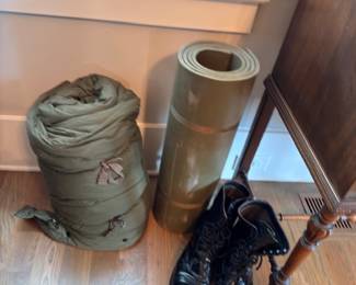 Military bedroll, sleeping bag, and combat boots