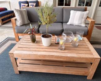 Teak patio sofa and coffee table with gray cushions