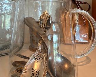 Glass mugs and ornate silver serving spoons