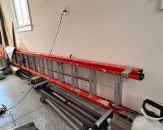 Red fiberglass extension ladder