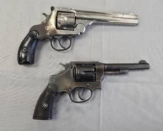 Two vintage 32 caliber revolvers.