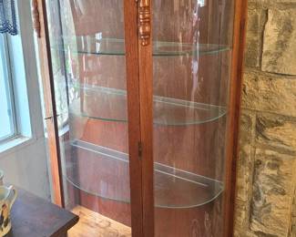 two curved curio cabinets