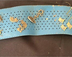 Lot 17: Blue perforated belt with assorted pins
