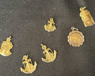 Lot 39: Gold-tone anchor and religious pendant charms