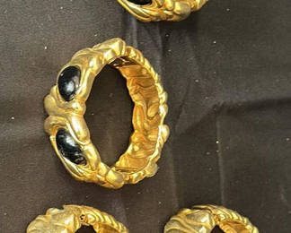 Lot 22: Set of five gold-tone textured bracelets with black stones