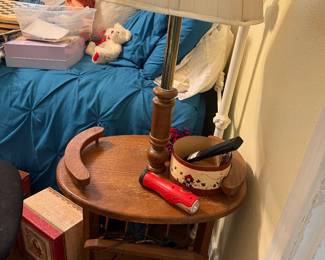 antique wooden side table floor lamp features a round top with raised handles and a lower shelf for storage.